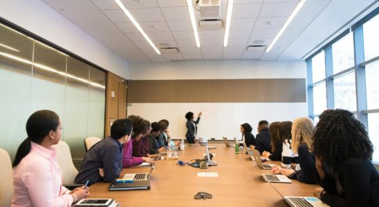 Business meeting with diverse team discussing projects in a modern conference room.